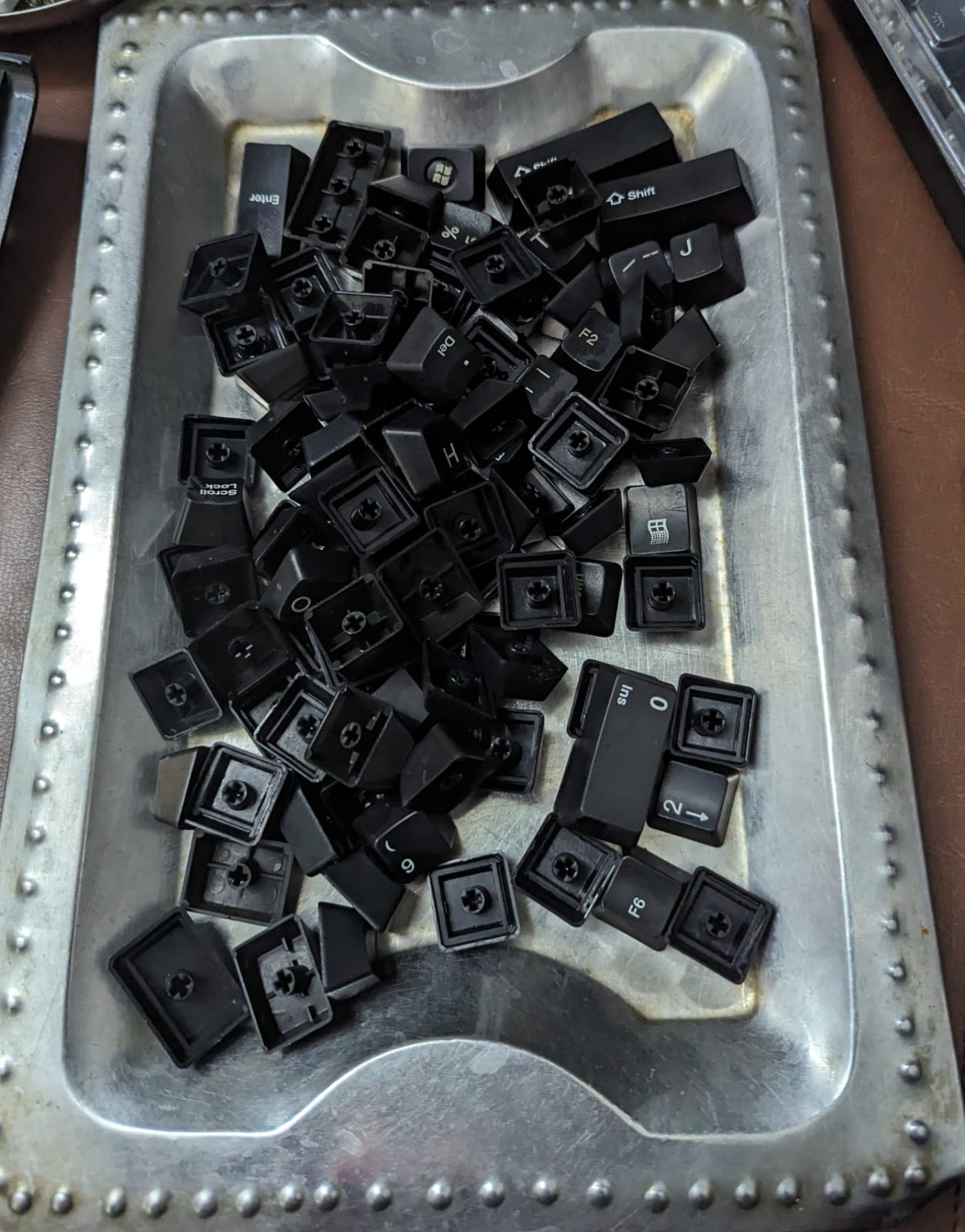 Cleaning each keycap individually.