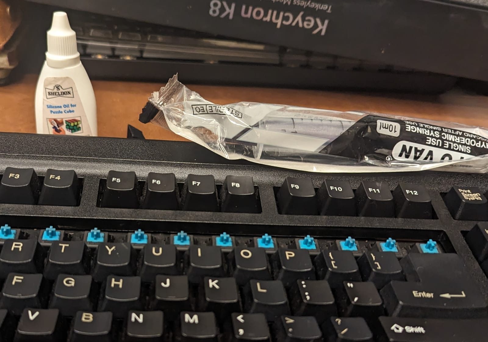 Using a syringe to apply lube to the key switches.